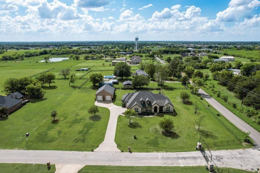 Welcome to this custom home loaded with features! Built in 2013, it offers 2,907 sq ft with 10 ft ceilings, solid core doors, hand-scraped hardwood floors, dual-zone HVAC, and two tankless water heaters, all in the gated community of Mallard Brook Estates. The primary suite features a stone fireplace, walk-through dual shower, large 13 x 8 walk-in closet with built-ins, and direct access to the patio and laundry room. The kitchen includes a 9 x 6 walk-in pantry, Italian Bertazzoni 6-burner gas range with pot filler, center island with chef’s sink, granite countertops, and ample cabinet space. The living area offers tray ceilings, a stone wood-burning fireplace, and expansive views. Secondary bedrooms each include private baths. Bedroom 3 is large enough to function as a second primary suite with direct outdoor access. Outside, enjoy a heated saltwater pool and jacuzzi (2023), covered patio, outdoor propane hookup, fully fenced yard, and 500-gallon propane tank. The utility room includes a sink, granite counters, and built-in cabinetry, with space for hobbies or crafts.  A standout feature is the 40 x 30 heated brick and stone shop with floor-to-ceiling OSB walls, 9,000 lb lift, 1,200 sq ft loft, cargo elevator, 220V power, 60-amp subpanel, and surround sound wiring. Room for 2 additional vehicles plus ample exterior parking. 
Luxury living with a rural feel—without sacrificing convenience.