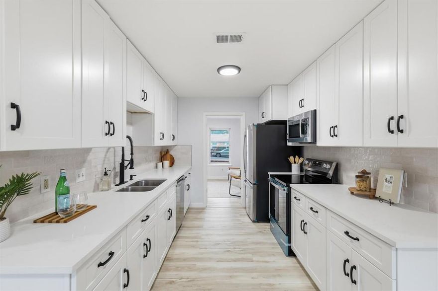 Updated, stylish, and ready to impress in Wedgewood. Set on an oversized lot in South Fort Worth, this refreshed home delivers clean lines, smart updates, and a modern feel throughout, all in an established neighborhood known for mature trees, larger lots, and easy access to major routes.

Light oak style flooring runs through the main living spaces, complemented by fresh neutral paint and recessed lighting that keeps everything bright and cohesive. The living room is anchored by a striking black brick fireplace with a natural wood mantel, creating a bold focal point without overpowering the space.

The kitchen is a true standout with crisp white cabinetry, quartz countertops, subway tile backsplash, matte black hardware and fixtures, and all new stainless steel appliances. A galley layout maximizes storage and prep space while keeping everything functional and streamlined.

The private primary suite offers a calm retreat with direct access to an updated bath featuring a walk in shower, modern tilework, black fixtures, and a dedicated vanity area. Additional bathrooms continue the clean aesthetic with quartz counters, updated lighting, and thoughtful finishes.

A covered patio overlooks the expansive backyard with room to entertain, relax, or play. Conveniently located near parks, shopping, and dining, with quick access to I 20 and I 35W for easy commuting. Fresh, modern, and FHA eligible, this Wedgewood home checks the boxes and then some.