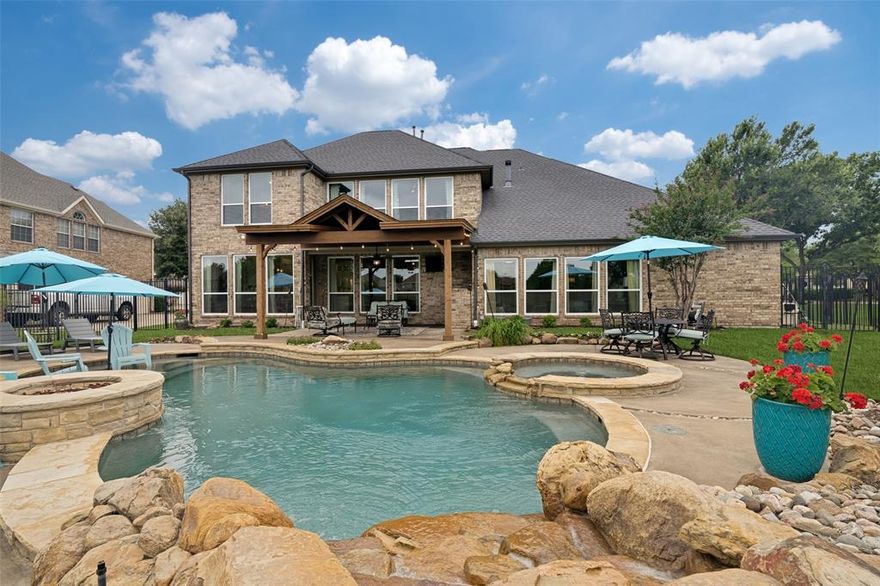 Beautifully upgraded 5-bedroom, 4-bath home on the golf green in the gated Broadmoor Estates section of Waterview, offering stunning views and a 3rd of acre lot with a lagoon-style pool, waterfall, fire pit & covered patio. Enjoy resort-style living with access to an 18-hole golf course, clubhouse, parks, trails, tennis courts, and a separate full size community water park—perfect for additional recreation and entertaining.
This home offers one of the most enhanced interiors in the neighborhood with hardwood floors downstairs, all new carpet, and new windows (2021). The expansive designer kitchen is a true centerpiece featuring custom cabinetry, two oversized islands, quartzite countertops, a professional-grade 36” range with second oven, built in beverage fridge, custom hood, and designer tile. A functional layout includes a large downstairs guest room next to a full bath, front study, formal dining, and open living area, plus a large game room and dedicated media room upstairs. The primary suite showcases a luxurious spa-inspired bath with an oversized wet room shower with multiple shower heads and a freestanding tub. Abundant storage throughout, oversized laundry room, and a 2-car garage plus separate 1-car garage. A rare opportunity offering extensive upgrades in all the right places with premium golf course frontage and views.