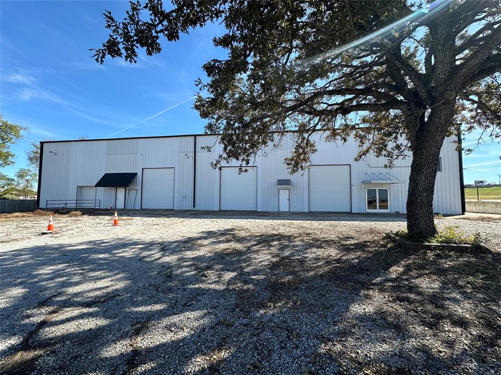 Commercial building in a fantastic location, located just off access road to I35. Building features 4 office spaces, 4 private restrooms, kitchen or break room area, common meeting room, and TONS of extra rooms for storage space or additional offices. Offices, restrooms, and storage rooms on multiple levels for added privacy. Central heat and air for all office areas and one storage or display room is cooled and heated by mini spit. Multiple large roll up doors and an off load dock off the shop potion of the space. There is plenty of parking and it is all fenced in for added security. The options are endless for businesses that could use this space.