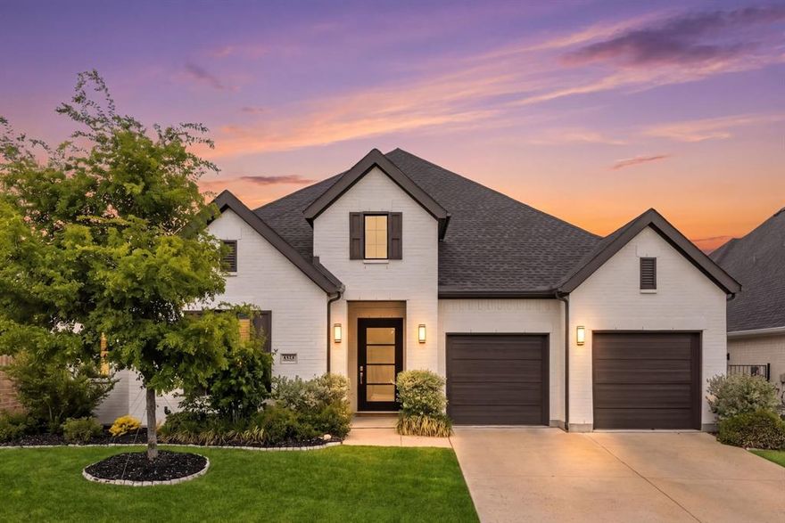Positioned within the exclusive gated enclave of Paradiso Valle in Stonebridge Ranch, this single-story residence is defined by its curated design and rare connection to nature. Set along a private creek with uninterrupted greenbelt views, the setting offers a sense of privacy and calm that immediately sets it apart, while the interior is expressed through clean lines, elevated finishes, and a cohesive material palette that creates an effortless, refined living experience. A welcoming entry with 13-foot ceilings sets the tone, while wide plank wood floors extend seamlessly throughout. The living room is both understated and striking, centered around a sleek fireplace and framed by sliding glass doors that open to the outdoor living space. The kitchen is defined by a sense of quiet precision, elevated by a suite of Wolf and Sub-Zero appliances, an uncommon distinction within the neighborhood. Granite and quartz surfaces, an apron-front sink, and extended cabinetry create a clean, cohesive backdrop. The dining area is wrapped in windows, drawing in natural light and greenbelt views. A dedicated study with vaulted ceiling and custom built-ins provides a tailored workspace, while the media room features wall-to-wall cabinetry, surround sound wiring, and layered lighting for a true at-home theater experience. The primary suite offers a private retreat with a vaulted ceiling and spa-like bath including a freestanding tub, dual vanities with vessel sinks, quartz surfaces, and an oversized frameless shower with rain head, bench, and niche. Secondary bedrooms are thoughtfully positioned, including a guest suite with walk-in closet. Additional features include a utility room with built-in cabinetry and sink, an oversized three-car garage with storage, and an extended covered patio overlooking the creek lot. Built in 2022, this four-bedroom, three-bath home offers an elevated standard of living within one of McKinney’s most sought-after gated communities.