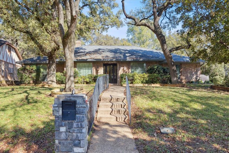 Welcome to this charming, has had 46 years of love with one owner, one-story home offering great curb appeal in an established, highly convenient neighborhood—just minutes from I-30, shopping, and dining. Looking for the next owner who will appreciate and love this house into a home and make many wonderful memories! ! Thoughtful features and a flexible floor plan make this property ideal for a variety of lifestyles. Inside, you'll find multiple living spaces, including the main living room with a slight step-down design, rich paneling, and a built-in wet bar—perfect for entertaining. The spacious kitchen features a unique carousel ceiling, recessed lighting, fresh paint, a built-in desk, and a large walk-in pantry. The adjacent laundry room provides ample space for an extra refrigerator or freezer. This home offers four bedrooms, including a versatile split bedroom that functions beautifully as a 4th bedroom, private guest suite, home office, or third living area. This blue room features its own private bath with a single sink, shower, and toilet, plus a dedicated closet. Two additional bedrooms share a convenient Jack-and-Jill bathroom. The primary suite is privately positioned and includes direct patio access, two large walk-in closets, and an ensuite bath with a separate shower, clawfoot tub, and a built-in seat that opens for additional storage. Outside, for privacy is remote controlled gate on driveway, and enjoy a fenced backyard that includes separation between the driveway and yard, plus railing along the exterior front steps for easy access. This home offers space, character, and functionality in a prime location—ready for your personal touch!  Carpet removed and seller offering $7000.00 contribution for buyer to select their own flooring where needed.  Den picture and bedroom picture are VIRTUALLY STAGED.  Seller thinks square footage is larger than TAD.