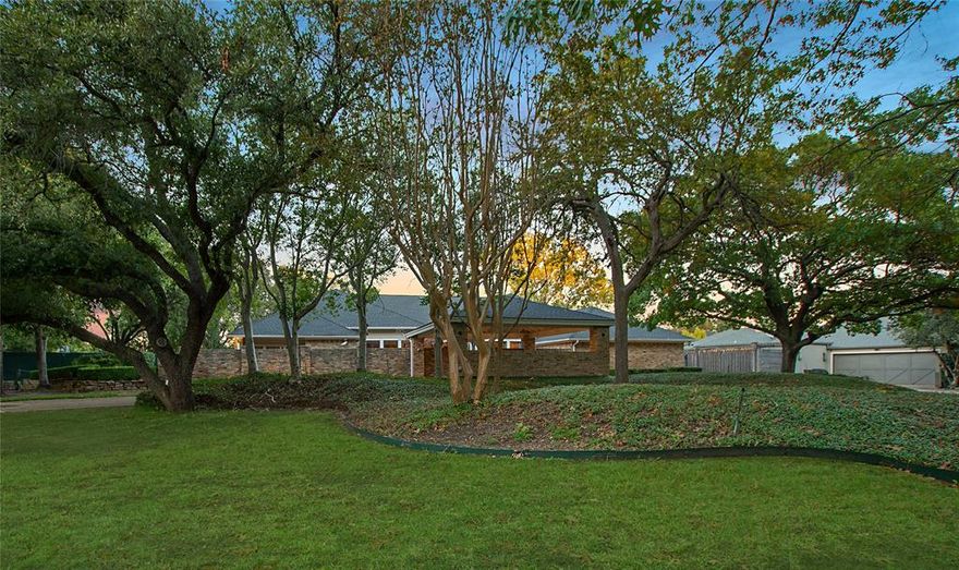 Prime Location & Golf Course Views! Situated in prestigious Bent Tree across the street from Bent Tree Country Club, this is a RARE opportunity to purchase a wonderful one-story transitional home nestled on an 0.82-acre corner lot featuring scenic outdoor spaces, a covered patio, pool & spa, sport court, lush landscaped grounds & also backs up to the 14th hole of the Preston Trail golf course. This idyllic setting is peaceful & serene yet it sets the tone for a sophisticated atmosphere for entertaining. Boasting fabulous entertaining spaces & an ideal floor plan with great bones, most of the rooms showcase the outdoors with its floor-to-ceiling windows & the rear overlooks scenic views of the pool, sport court & golf course. It is an incredible opportunity to update the home to perfection & 2024 standards — although it is move-in ready and has been well-kept. Details include an open floor plan with 9- & 11-foot ceilings, spacious oversized gathering areas, parquet hardwoods & travertine flooring, handsome millwork, deep molding, 5 bedrooms, 5 baths, oversized formals, a handsome library with built-in bookcases, oversized granite island kitchen with a breakfast bar, large breakfast area & also opens to an expansive light-filled sun room with a vaulted ceiling plus a spacious den-game room. Enormous & private, the luxurious primary suite features its own sitting area, a brick fireplace, built-ins, neutral carpeting, an office & an expansive bath with a soaking tub, separate shower plus His & Hers vanities & large walk-in closets. 4 additional bedrooms are spacious & are served by 3 elegant baths. Outside, the exceptional outdoor oasis additionally features a serene private courtyard in the front with its shimmering fountain & a landscaped flagstone walkway leads to the rear of the home. A vaulted porte cochere with its expansive circular drive plus a 2-car attached garage completes this stunning property. Property is an estate & is to be sold AS IS – no repairs.