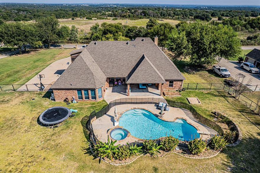 Are you looking for a beautiful 4.3.5.3 custom built home in Aledo ISD. This stunning home offers an open concept and is located on 1 lush acre with a pool.
The Kitchen boasts of granite counter tops and beautifully stained custom cabinets, large walk-in pantry. There are  two primary suites and a bonus room. Enjoy the extended patio overlooking the inground pool and spa with a water feature. 
Home has just updated with new paint and carpet.
Don't let this stunning home pass you by.