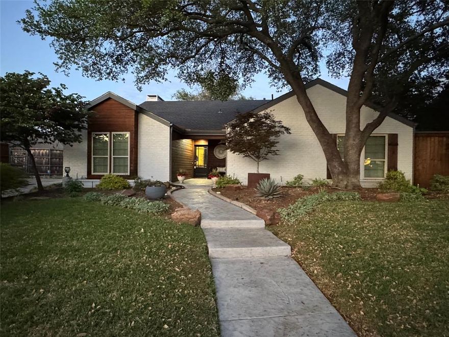Charming updated North Dallas Home in a quiet peaceful neighborhood.  Enter to an entire home of recently installed engineered hardwood floors.  Beautiful living room with soaring ceilings, gorgeous decorative remote controlled fireplace with glass doors, beautiful shelves. French door access to covered serene stamped concrete back porch with pretty landscaping & set up for maximum entertainment. Long side yard could also be dog run. Come back inside to the dining area and the newly remodeled kitchen.  Don't miss the crushed granite sink and natural quartz countertops, pretty backspash, stainless oven and microwave. Downdraft electric glass cooktop, Kitchenaid stainless dishwasher.  This unique open kitchen has a breakfast bar on 2 sides for great entertaining and openness. Second living open to kitchen with wall of windows looking out to the 2nd outdoor living deck and yard.  Another wall of windows and French doors in the hall lead to the side entertainment area.  Ahhh come enjoy your morning coffee here. 2 roomy secondary bedrooms on this south wing of the home share a newly renovated bathroom with a REBATH remodel for a clean streamlined shower tub and double sinks. One of the bedrooms comes complete with a wall murphy bed and can be used as a bedroom, playroom or office.  Lots of closet space  in both bedrooms too.  Utility is behind updated doors in the hall for easy access.  Master Bedroom overlooks the front yard and is super roomy with a high ceiling and beautiful beam.  Remodeled master bath with gigantic gorgeous shower,  updated vanity and mirror, and lots of light.  Huge closet with cabinets inside.  Owners and previous owners have babied this home and kept it very updated and beautiful.  The drive up appeal is fantastic - interior lot by the alley so neighbor noise is minimal.  2 fenced yards designed with entertaining & relaxing in mind.  Come live in this wonderful home asap. Open House Saturday 1-3pm on April 11.