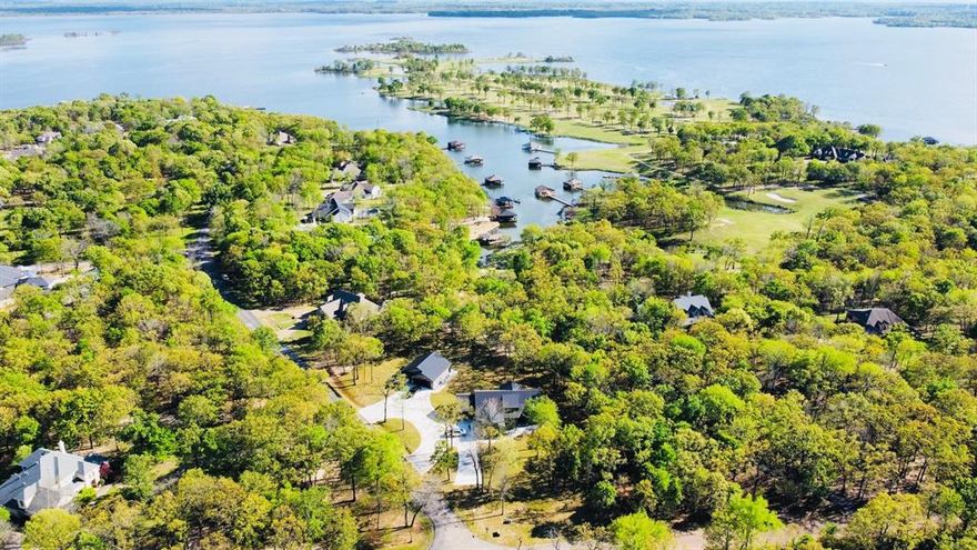 Two Waterfront Custom Dream Homes on 1.49 acres with creek view and 1.5-acre leaseback in the sought-after Land's End gated community! The main home offers 4,314 sqft under a seamless metal roof with 3 bedrooms, a study, and 2 bathrooms. Highlights include a 3-car garage, open living kitchen with oversized island, gas stone fireplace, vaulted ceilings with distressed pine beams, oversized walk-in shower, huge closet with windows and built-ins, beautiful stone accents, circle and extended driveway, sidewalk, covered patio with pine ceiling, foam insulation for low utility costs, stained concrete floors, and epoxy flake garage flooring. Both garages are heated and cooled.  The second home offers 1,608 sqft under roof with 1 bedroom, 1 bath, and a 2-car garage.  It features an open living kitchen, breakfast bar, and epoxy garage flooring.  The lush, landscaped lot sits beside a creek, with gorgeous mature trees leading to the Bass Capital of Texas — Lake Fork. Enjoy world-class fishing or take advantage of community amenities including The Links at Land's End 18-hole golf course, pool, pavilion, and dining at Jackie's Pub. This one-of-a-kind property is just 90 minutes east of Rockwall and the Dallas area.  Property could be sold furnished as well.