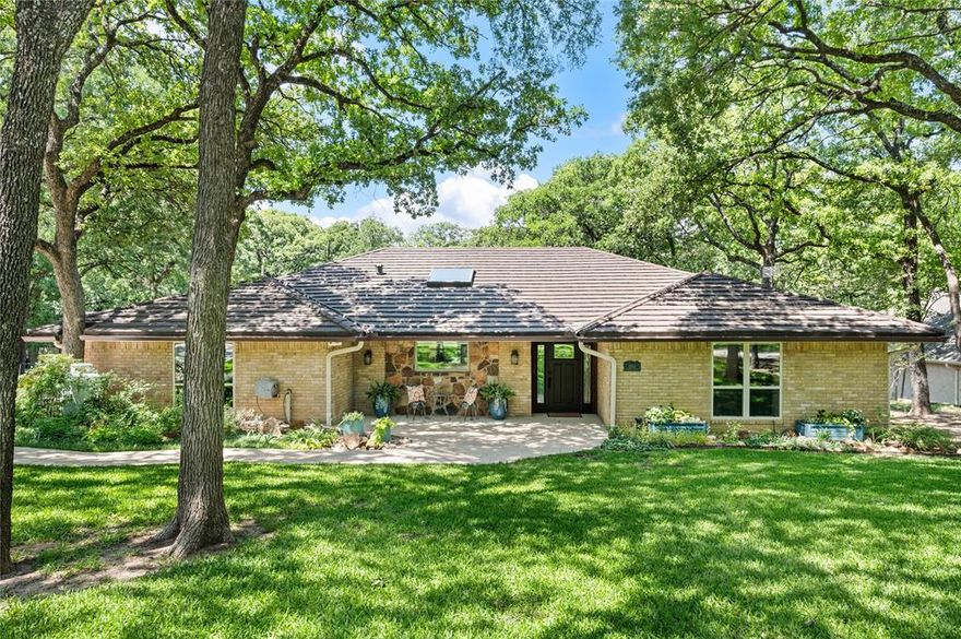 Tucked away in the highly desirable Lake Arlington area on a quiet cul-de-sac street, this exceptional property offers a rare combination of luxury, functionality, & natural beauty on over HALF AN ACRE of park-like, meticulously curated grounds. From the moment you arrive, the home delivers undeniable wow factor, highlighted by the striking 2025 Class 4 Decra Shake stone-coated steel roof, manicured trees, an extra-wide driveway, two 200 amp legs that supply more than enough power for the house, the 50 amp hook up on the RV - boat parking pad and the detached 10x20 WORKSHOP. Every detail in and out reflects intentional design & quality craftsmanship. A stunning 2020 remodel transformed the home into a light-filled, modernized floorplan with an open-concept great room anchored by a TRUE CHEF'S KITCHEN. Outfitted with a 48-in THERMADOR GAS cooktop & premium appliance suite, a built-in counter-depth refrigerator & freezer, Boos Block & Italian tile countertops, & extensive storage, this space is as functional as it is beautiful. The great room is highlighted by a vaulted, beamed ceiling, cedar woodwork, and a stone fireplace with hearth. Two casement windows frame serene views of the landscaped yard. Updated windows, paint, & flooring enhance the cohesive, modern feel. The split-bedroom layout offers a private primary suite with peaceful views of the backyard. The experience continues beyond the walls of the home, unfolding into a serene, garden-inspired setting that offers both privacy & a sense of escape. The grounds are truly extraordinary, featuring 2 greenhouses, mature & meticulously maintained perennial gardens, herbs, a producing asparagus patch & two 6ft organic vegetable gardens with an integrated watering system. Flagstone patios & winding walkways create multiple outdoor living spaces. Desirable location, over half an acre, extensive interior updates, RV or boat parking, and a fully powered workshop. Rare opportunity.