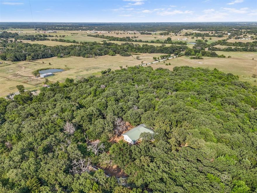 Set on 10.5 acres in Collinsville, TX—just minutes from Lake Ray Roberts—this property features 4-bedroom, 2-bath home spans 2,376 sq. ft. and is surrounded by mature trees that provide shade and privacy.
The house offers plenty of potential for customization, while the land itself is the true highlight. With room to roam, space for livestock or gardening, and a workshop with electricity connectivity is ready for projects or storage, this property offers multiple opportunities.
Whether you’re seeking peace, privacy, or a place to create your own vision in the countryside, this acreage delivers the perfect setting.
