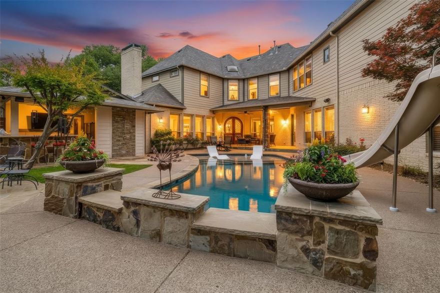 Enjoy resort-style living on a rare, beautifully private .70-acre estate in the heart of Lakewood. Set on a picturesque corner lot, this modern ranch-inspired residence is surrounded by mature trees, offering exceptional privacy & serene, tree-lined views from nearly every angle with an elevated yet comfortable lifestyle blending nature & refined design. Originally taken to the studs & reimagined in 2017, the home seamlessly merges timeless craftsmanship with modern luxury. Spanning nearly 4,900 square feet, it offers 5 bedrooms, 5.2 baths & multiple living areas designed for both effortless daily living & sophisticated entertaining. Inside, the open-concept layout features solid hardwood floors, abundant natural light & expansive views of the pool and lush grounds. The chef’s kitchen serves as the heart of the home, anchored by an oversized island and high-end custom finishes, flowing seamlessly into the dining area & dual living spaces. A striking oversized stone fireplace and custom built-ins create a warm yet sophisticated focal point. The backyard is a true private retreat, designed for year-round enjoyment with a stunning deep saltwater pool, a 5' firepit, covered patios, flagstone terraces & a fully equipped outdoor kitchen. The game room studio opens directly to this outdoor oasis, creating an ideal indoor-outdoor enjoyable atmosphere. A thoughtful layout includes a private main-level guest suite with a secondary living area, perfect for extended stays or multigenerational living. Upstairs, the spacious primary suite offers a serene retreat with a spa-inspired bath, dual vanities, soaking tub, dual-head shower, oversized walk-in closet & dedicated shoe cabinet. Two of three add'l bedrooms feature ensuite baths for added privacy. Ideally walkable to Lakewood Elem & Lakehill Prep schools, this exceptional property delivers a rare combination of space, privacy, craftsmanship & lifestyle - An estate where luxury, comfort & experiences come together perfectly