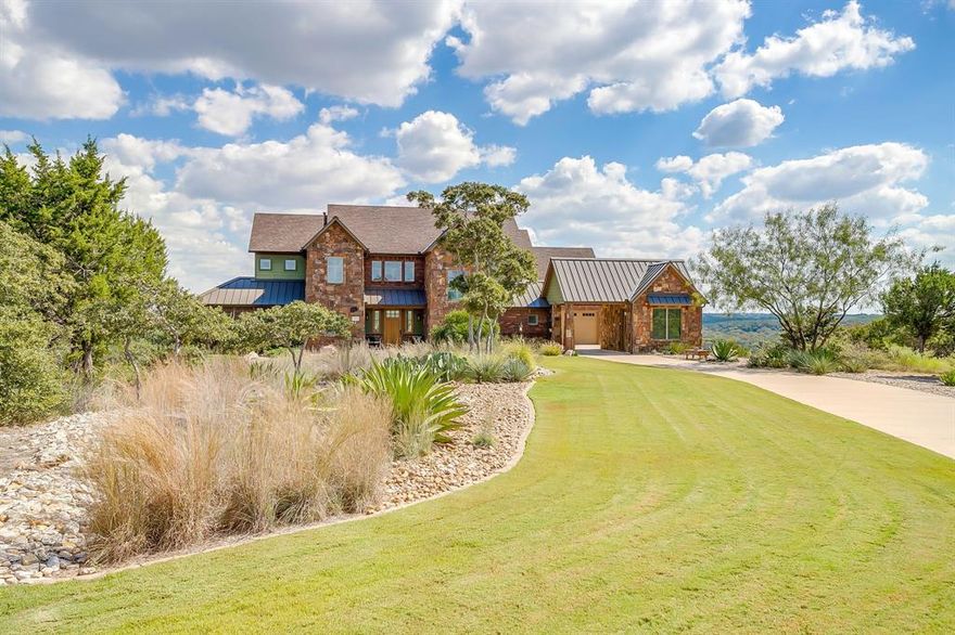 Step into the extraordinary at 8225 Scotscraig Ct, a masterfully crafted home located in the gated enclave of the Retreat Country Club on a private cul-de-sac lot with sweeping, panoramic views of the North Texas Hill Country and the dramatic Brazos River valley bluffs. The drive-up reveals an impressive façade that sets the stage for the refined lifestyle within. Towering floor-to-ceiling windows and rich wood flooring usher you into an open,  interior that mixes hill country views, classic vibes and luxury feel where natural light dances through a spacious great room anchored by a majestic stone fireplace—all wrapped up in a hill country modern feel.  This 3,863-sq-ft, 4-bedroom, 4-bath sanctuary, built in 2017, sits on approximately 0.805 acres and offers three garage bays plus an elevator. Imagine waking each morning to uninterrupted vistas, stepping out seamlessly from your interior to expansive outdoor living: a built-in Coyote grill, multiple seating terraces, rugged stone columns framing the horizon, a brand-new hot tub—and yes, even vintage Texas Rangers stadium seats repurposed for your personal “stadium-style” view of the valley below. A cup of morning coffee to figure out if it's a golf day, river day or use of the vast amenities at The Retreat! The primary suite is a pampered retreat in its own right, offering spa-style comforts and a private sauna with Hamm Creek valley views. Upstairs, a loft study and bedrooms with private balconies provide flexibility for entertaining, living and lounging—all while taking in the vistas. The cleverly designed floorplan integrates thoughtful amenities: a mud room, dog apartment, walk-in pantry, and storage galore. 
Membership to the Retreat Country Club is included. Don’t let this rare opportunity slip away. Schedule your private showing today and discover how life can look at 8225 Scotscraig Ct—where every day feels like a getaway. Contact us now.