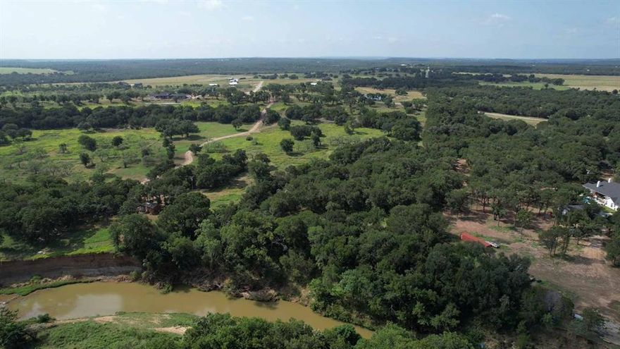 Discover an exceptional opportunity to own 6.339 acres in the scenic Sierra Vista Ranch, one of the few lots that backs up directly to Palo Pinto Creek! Enjoy breathtaking panoramic views across rolling hills and lush countryside, teeming with deer and other wildlife. Barndominiums are allowed, making this an ideal setting to build your dream home with plenty of privacy and wide-open skies. Choose your own builder! This property combines rural tranquility with convenient access, just 53 miles from Fort Worth and a short drive to nearby towns including Weatherford, Granbury, Stephenville, and Mineral Wells. Experience the best of country living within reach of city amenities! An additional 6.339 acres is available next door. MLS#21130045
