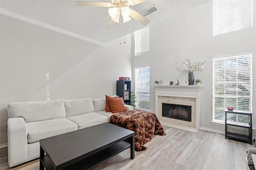 Light-filled two-story condo located in the gated Preston On The Lake community. The main living area features vaulted ceilings, a cozy wood-burning fireplace, and durable luxury vinyl plank flooring. The kitchen includes granite countertops, ample cabinet space, and opens to the dining area for easy everyday living. Upstairs, the primary suite offers an ensuite bath and walk-in closet. The loft area is currently set up with a bed and works well as a guest space, home office, or flex area. A half bath downstairs adds convenience for guests. Enjoy access to community amenities including a pool, clubhouse, walking and biking trails, greenbelt areas, and a peaceful lake setting. One covered carport space included. HOA covers water, sewer, pest control, and use of community facilities. Convenient North Dallas location near Preston Road with easy access to shopping, dining, and major highways.