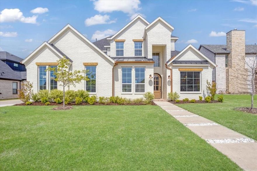 Experience unmatched design and detail in this Denison dream home. Step into a grand foyer with double-height ceilings and an arched mahogany front door that sets the tone for the elegant design throughout. The open layout connects the living room and kitchen, creating a perfect space for entertaining. The kitchen shines with designer light fixtures, custom cabinetry, and thoughtful details that elevate everyday living. A bold metal custom door leads directly to your patio, offering an ideal setting for outdoor gatherings, relaxation, and enjoying the serene backyard. The primary suite is a true retreat, featuring a spa-like bathroom with luxurious finishes and a picture window that lets in natural light, complemented by blackout shades for ultimate privacy. The bathrooms feature upscale finishes, including custom white oak cabinets. This floor plan has it all: an office, a dedicated flex room, media room, a balcony to unwind outdoors, and an inviting play area. The three-car garage provides ample space for vehicles and storage, and includes a 220v electric car charging outlet, making it perfect for modern living and future convenience.