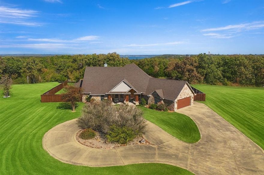 Welcome to this impressive custom lake-view home in the Texoma Bluffs community of Gordonville, Texas. Situated on 2.18 acres overlooking Lake Texoma and Corps of Engineers land, this property offers a blend of comfort, quality, and scenic surroundings. The living room features soaring vaulted ceilings and a wall of windows that bring in natural light and highlight panoramic lake views. The gourmet kitchen includes walnut cabinetry, granite counters, and an expansive island designed for cooking, gathering, and everyday functionality. The primary suite includes a spacious bath and a well-designed walk-in closet. Outdoors, a covered patio provides a comfortable space for relaxing or hosting, while the landscaping enhances privacy and complements the natural setting. Built in 2011, the home incorporates energy-efficient and modern features throughout. The property adjoins U.S. Government land near the Lake Texoma shoreline and provides access to over 14 miles of hike and bike nature trails known as the Cross Timbers Trail. With its thoughtful design, contemporary amenities, and scenic location, this home offers a distinctive opportunity to enjoy the Lake Texoma area.