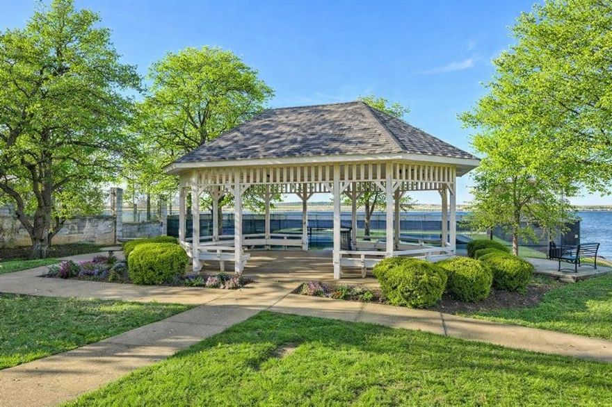 Welcome to 2101 Vista Ridge Ct, located in the sought-after lakeside community of Bay Club on Lake Arlington, where an active lifestyle and beautiful surroundings come together. This custom-built steel framed home showcases timeless style and quality craftsmanship with thoughtfully designed spaces ideal for both everyday living and entertaining.
The home offers wonderful curb appeal with a circular driveway, side-entry garage, and a private covered front porch.
Inside, you’ll find rich wood floors, classic wood shutters, and custom millwork that add warmth and architectural character throughout. Multiple dining and living rooms, along with two fireplaces, create cozy gathering spaces for relaxing evenings or hosting friends and family.
Designed with entertaining in mind, the home features a wet bar for hosting dinner parties or casual gatherings with ease. At the heart of the home is a chef’s dream kitchen featuring Viking appliances, a generous prep space, and a layout ideal for those who love to cook and entertain. Enjoy the outdoors year-round in the bright, peaceful sunroom, offering the perfect place for morning coffee and a good book. 
The private primary en-suite offers a comfortable escape with custom-built-ins, dual vanities, and a large walk-in closet, combining style and functionality. 
Step outside to a welcoming outdoor area designed for al fresco dining and entertaining, making it easy to host memorable evenings with family and friends while enjoying beautiful Texas nights. Residents enjoy amenities including pickleball and tennis courts, a clubhouse, a playground, a fishing and boat dock, and serene lakeside spaces. The community is located near the ACTIV Center, local golf courses, and Arlington’s vibrant Entertainment District, with easy access to dining, sports, and concerts. 
Don’t miss the opportunity to experience this exceptional home and the Bay Club lifestyle in one of Lake Arlington’s most desirable, gated lakeside communities.