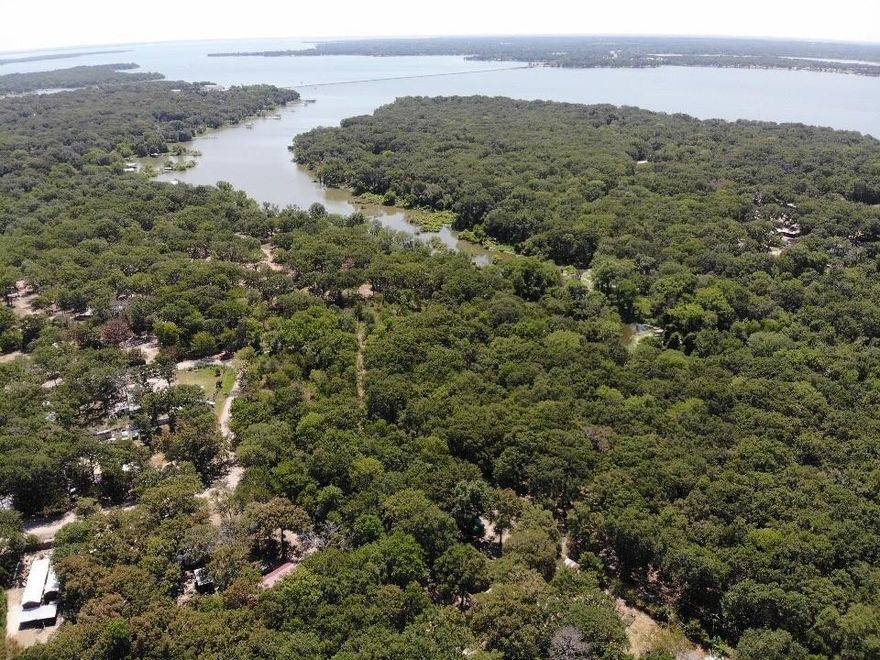 Beautiful lot #2 with large hardwoods backing up to lake Tawakoni. Easy access to lake Tawakoni from back of property. No neighbors to rear of property make this the perfect get away, lake home or air bnb spot. No known restrictions and mobile homes allowed. Selling lot #4 and #5 can be sold together.