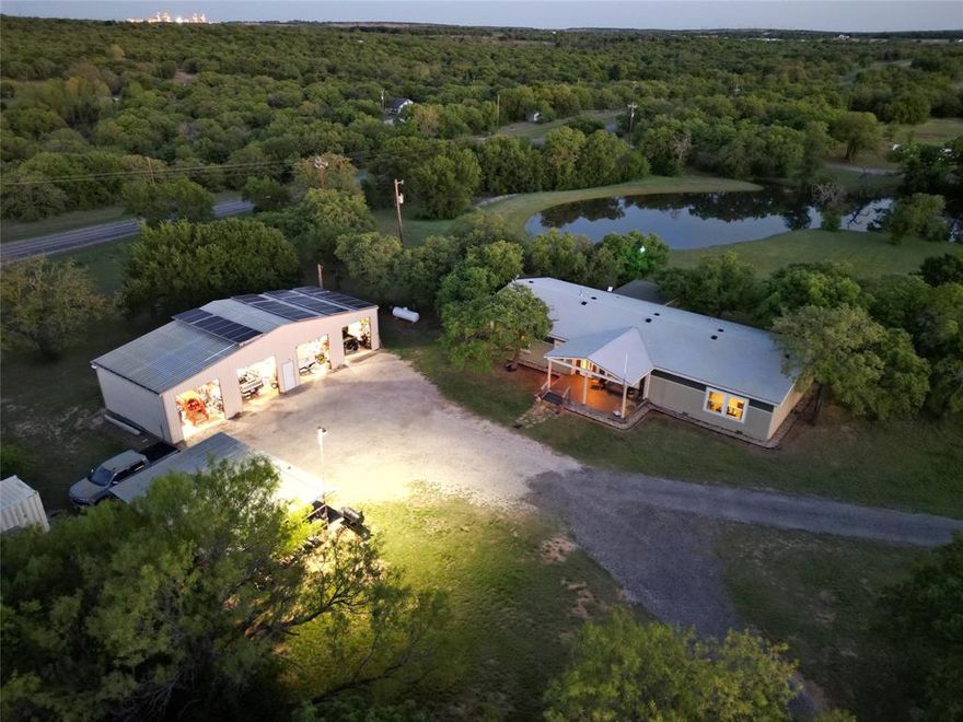 Exceptional 70.70-acre turnkey ranch loaded with improvements and recreational appeal with 7 strand barbed wire fencing around most of the property. Features a 2017 Palm Harbor home (2,584 sq ft) built with upgraded 2x6 walls, energy-efficient windows, and Zone 3 insulation, set on concrete runners with a pier system and anchored every 6 feet. A 25x60 insulated shop with HVAC provides excellent workspace. The land offers 4 ponds (3 stocked with Texas largemouth bass, channel catfish, and brim) FREE WATER and ELECTRICITY via 3 producing water wells, multiple 2,600-gallon storage systems and an aquasana water filtration system PLUS a rainwater collection with its own 2,600 gallon storage tank. Solar system includes 28 SunPower panels, Sol-Ark inverter, and 2 battery backup. Two turf runways approx. 1,100 ft make this a rare find for STOL enthusiasts. RV hookups, covered pavilion, climate controlled storage container, and prime hunting setup complete the package.