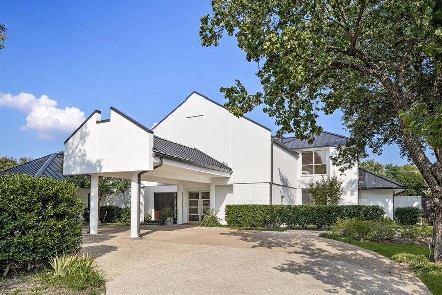 Live a life of luxury and leisure in this modern masterpiece, set on nearly an acre of manicured grounds. This isn’t just a home; it’s your own private resort, designed for both vibrant entertaining and serene relaxation. The outdoors is where the magic happens. Imagine a beautiful afternoon spent playing on your very own full-size private tennis court—complete with lighting for evening matches—which also features a dedicated pickleball court. The expansive yard offers a large green space surrounded by mature trees, perfect for quiet afternoons or a game of frisbee. When it’s time to unwind, gather around the firepit under the stars or take a refreshing dip in the sparkling pool. An expansive covered patio hosts a full outdoor kitchen, making it effortless to host unforgettable barbecues and poolside parties. A grand circular drive provides an elegant welcome for you and your guests. Inside, the home is a celebration of light and space. Walls of windows and sliding glass doors blur the line between the indoors and your private outdoor sanctuary. The formal dining room is perfect for hosting elegant dinner parties, featuring heated built-ins for serving, while the polished marble flooring adds a touch of timeless sophistication. The gourmet kitchen is the heart of the home, equipped with a Sub-Zero refrigerator, a 6-burner gas cooktop, double dishwashers, double ovens, and a warming drawer. With polished granite on the floors and countertops, Seimatic cabinetry, and artistic lighting, this space is both beautiful and functional. This home offers ultimate comfort for everyone. The primary suite is a true spa-like retreat with dual sinks, a luxurious walk-in shower with dual heads and body sprays, and two separate toilets. The secondary bedrooms have ensuite baths and walk-in closets, ensuring every guest or family member enjoys their own private sanctuary. Close to top-tier private schools and high-end retail and dining, with easy access to the Dallas North Tollway.