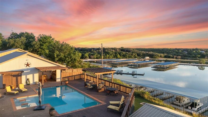 Stunning Lake Whitney Estate – A Private Oasis with Endless Entertaining Possibilities

Perched above the pristine waters of Lake Whitney, this exceptional lakefront estate offers breathtaking sunrise and sunset views over the brand-new marina. Designed for both relaxation and entertainment, the property boasts a resort-style pool, several covered cabanas, and a beautifully turfed area perfect for evening gatherings overlooking the water.

The main residence features 3 generously sized bedrooms, 2 full bathrooms, a beautifully appointed kitchen, and two inviting living areas that seamlessly blend comfort and style. An attached guest house adds flexibility with 2 spacious bedrooms and a full bath — ideal for hosting family and friends.

A massive, fully equipped garage offers ample space for cars, boats, golf carts, and all your lake-life essentials. The gated entry welcomes you to multiple unique areas of the property, including a large entertainment room, a versatile storage building, and more – all thoughtfully designed for convenience and enjoyment.

Located just a short golf cart ride from the lake’s edge, you’ll enjoy easy access to a private boat ramp and marina. Nestled on a quiet, gated road, this property offers a peaceful retreat with the charm of a small-town atmosphere. The town of Clifton, only minutes away, provides a variety of restaurants, shops, and local attractions — the perfect blend of lakeside seclusion and community connection.