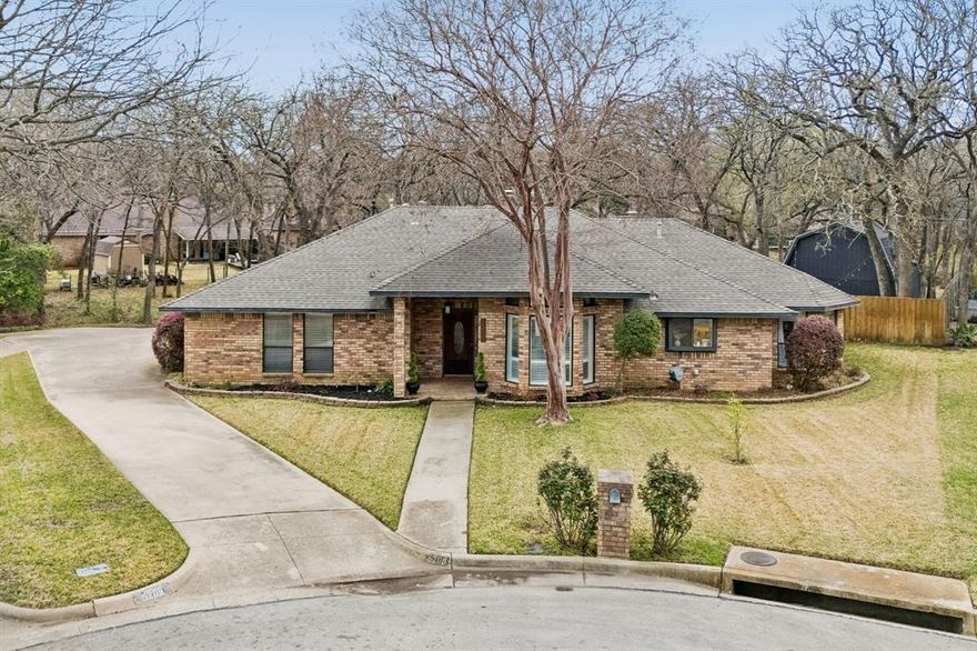 Welcome to 5209 Commander Court, a beautifully situated single-family home on a very quiet & hidden cul-de-sac in the desirable McKamy Oaks Addition of Southwest Arlington. This well-maintained 3-bed, 2-bath residence offers approximately 2,015 square feet of thoughtfully designed living space and sits on a generous 0.41-acre lot with mature trees and creek frontage. Step inside to the inviting living area with a cozy fireplace, full wet bar, and abundant natural light. The eat-in kitchen features solid surface counters, walk-in pantry, and an open breakfast nook, making everyday meals and entertaining effortless. A separate media room adds flexible space for movie nights or a home office, with the potential for building out extra living quarters. The primary suite provides a private retreat with a walk-in closet and ensuite bathroom that gives luxury spa vibes. Two additional bedrooms offer comfort and versatility for family, guests, or work-from-home space. Enjoy outdoor living with a spacious backyard immersed in nature. Conveniently located near shopping, dining, parks, and major thoroughfares, this home combines neighborhood charm with easy access to all Arlington has to offer. HVAC replaced within the last year. New tankless water heater installed approx. 3 years ago. No HOA and zoned to Wood Elem, Boles JH, & Martin HS. Don’t miss the opportunity to make this classic home yours!