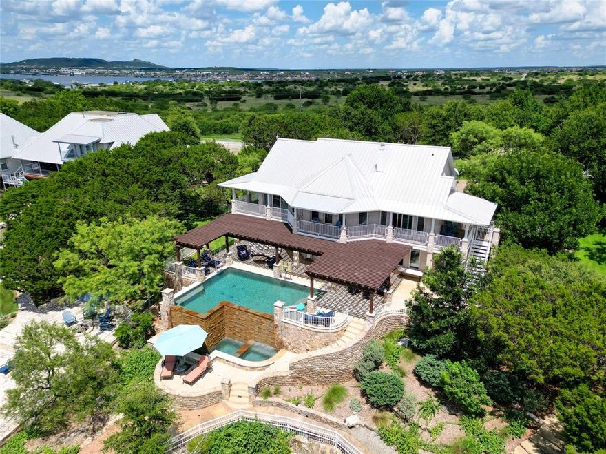 POSSUM KINGDOM LAKE! LOCATED IN GAINES BEND ON THE CLIFF LINE*THE ULTIMATE IN LAKE VIEWS*IMAGINE THE BEST VIEWS OF THE FAMOUS FOURTH OF JULY FIREWORKS FROM YOUR LAKESIDE PATIO*ONE ACRE LOT*NESTLED IN A LARGE GROVE OF TREES*PRIVACY ABOUNDS*GATED NEIGHBORHOOD*BOAT HOUSE WITH BOAT LIFT, 2 SKI LIFTS, UPPER LEVEL WITH TRAPEZE STYLE SWING, LEAP HANDLE FOR FUNS WAYS TO JUMP & DIVE OFF BOAT HOUSE*STURDY GANG PLANK-WALKWAY FROM BOAT HOUSE TO LAND*UMBRELLAS, TABLE, LOUNGING CHAIRS AND ALL ITEMS IN THE HOME AND YARD WILL CONVEY, CALL FOR ANY EXCLUSIONS*INFINITY POOL WITH BUBBLERS PROVIDE HOURS OF FUN AND ENTERATINMENT-BUILT IN BASKETBALL NET IN POOL, PEBBLE TECH FINISH*LENAI PROVIDES PARTIAL SHADE FOR SEATING AREA BY THE POOL*TANNING LEDGE & BENCH SEATING IN  POOL* A “LOOK OUT POINT” IS BELOW THE POOL LEVEL WITH PANORAMIC VEIWS OF THE LAKE AND A WALL OF STACKED STONE AS A BACKDROP*DON’T MISS THE LOVELY OUTDOOR LIVING AREA WITH COZY OUTDOOR FURNITURE, LOCATED TO THE LEFT OF THE FRONT STAIRWAY*PROFESSIONALLY LANDSCAPED WITH MANY DIFFERENT PLANT VARIETIES*LAWN IS IRRIGATED BY THE LAKE*BASKETBALL COURT*METAL ROOF ON THE HOME AND ALL STRUCTURES*THE 2 STORY HOME HAS A LOVELY KITCHEN, FAMILY ROOM, PRIMARY ENSUITE, BREAKFAST NOOK & BATH ON THE UPPER LEVEL*THE LOWER LEVEL FEATURES A GAME ROOM, 3 BEDROOMS, A GUEST BATH AND A KITCHENETTE*2 CAR DETACHED GARAGE WITH WORK BENCH*DON’T MISS THIS OPPORTUNITY TO OWN THE BEST LOCATION AT POSSUM KINGDOM LAKE*SEE AMENITIES & FEATURES LIST, 360 TOUR AND FLOOR PLANS ON NTREIS MEDIA*YOU MAY DISCOVER YOU CAN’T LIVE WITHOUT IT!