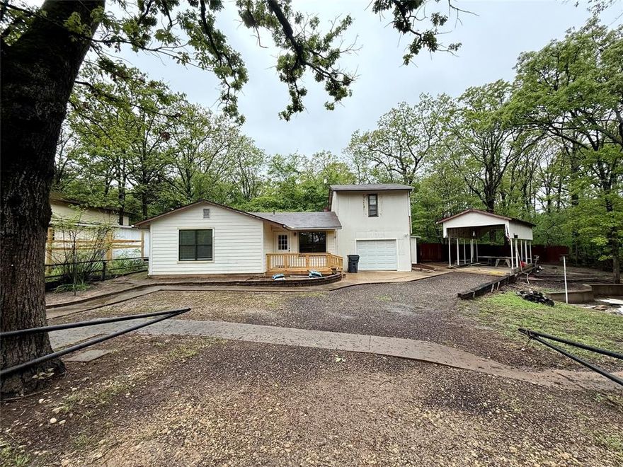 This is a one of a kind property in the gated Lake Fork Community of Steamboat Shores. Featuring a completely remodeled 2 bedroom and 1 bath primary residence with a studio apartment above the garage. There is a new roof, beautiful vinyl plank flooring and beautifully remodeled shower in primary bathroom.  The home is located on 3 lots at the end of a cozy cul-de-sac with a large RV cover and additional tandem boat or car parking.  There is a one car garage with washer and dryer hookups.  The studio is terrific for guests as it has a private entrance and a cute little screened in sunroom.  There is a cute kitchenette and walk-in closets for storage. Steamboat Shores features a private boat ramp and dock, pool and playground.