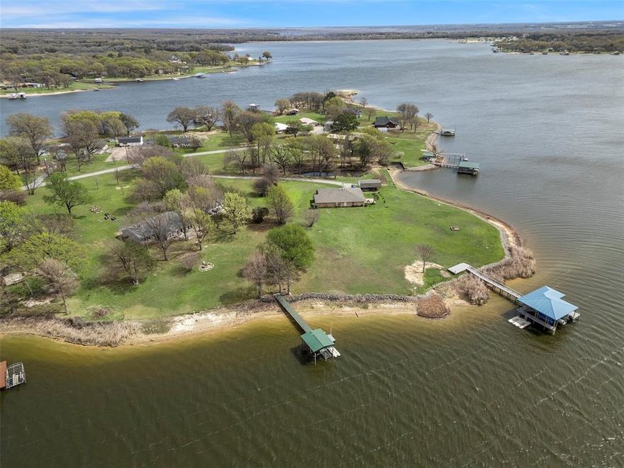GREAT VIEWS!-LAKEHOUSE on the WATER! Breath-taking 180 DEGREE VIEWS OF THE WATER! Beautiful 2.33 ACRE property with private dock on Lake Bonham-perfect for fishing, water skiing, boating, tubing and jet skiing! Just 1 hour North of DFW. Located on the coveted Beavers Point Peninsula of Lake Bonham.  WAKE AT THE LAKE with the BEST VIEW of the water from the large primary suite with UPDATED bath.  Ready for lake time fun with lots of room to play and entertain family and friends. This lot has covered Boat dock with electric lift and jet ski float. Beautiful drive-up with the trees canopying the driveway. Inside this beautiful home features a large living room with soaring ceilings, easy care laminate wood floors and cozy brick fireplace. This open concept floor plan is perfect for entertaining friends and family! Spacious kitchen with lots of cabinet storage, breakfast bar, and great flow right in to the dining area with brick accent wall overlooking the water. Light & bright sunroom-game room makes for a great 2nd living space for relaxing and game nights with lots of cheery windows framing the beautiful views of the property. Updated vinyl windows on the house, large storage shed with concrete floor for all the toys, raised garden beds, and so much more! This clean, updated and well maintained lake house is move in ready and you can start enjoying it the first weekend!! Pride in ownership can be felt the minute you walk in the door at this cherished lake home that holds many memories- Now its YOUR TIME to EXPERIENCE THE LAKE LIFE! Don't miss out!
