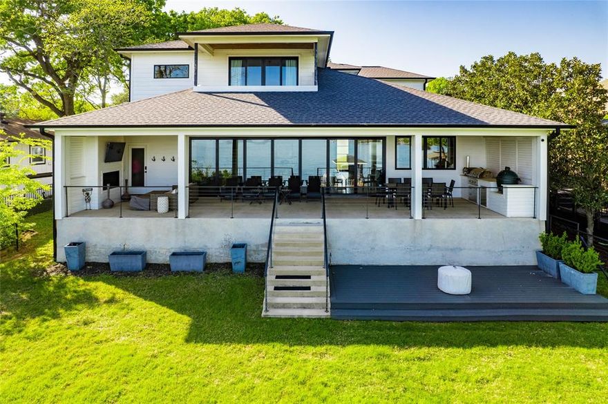 Experience the perfect blend of modern elegance and lakeside living in this 2019-built modern farmhouse.  Thoughtfully designed with tasteful finishes throughout, this home offers spacious open-concept living with breathtaking open water views. The light and airy chef's kitchen has a stunning 10 ft island serving bar ,  high end appliance package and gas cooking  to elevate every culinary experience.  The incredible butlers pantry boasts a beverage fridge and a separate wine fridge .  Expansive folding glass doors seamlessly connect the indoors to the spectacular outdoor living area, featuring a fireplace, outdoor kitchen, built-in ceiling heaters , motorized patio screens and a TV - ideal for year round entertaining.  The primary suite boasts a spa-inspired bath and opens to a private balcony overlooking the water. 4 guest en suites.  The fully fenced yard provides space to enjoy the outdoors, while the boathouse and person water craft lifts complete this dream waterfront retreat.