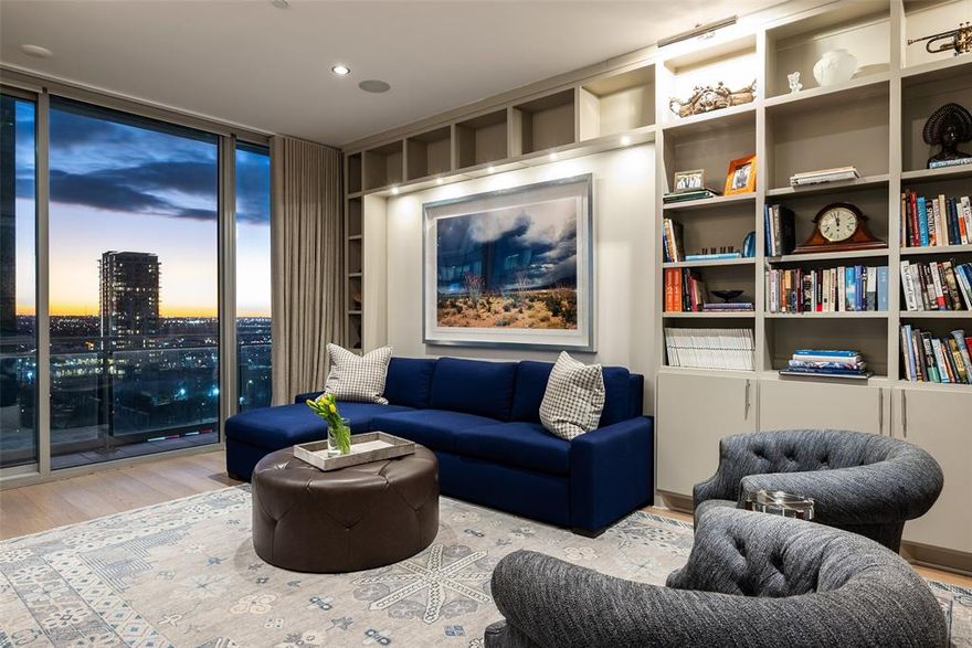 Set within the sought-after Azure Condos, this unit offers a rare blend of sophisticated design, smart-home functionality, and seamless indoor–outdoor living. This 952 SF residence features one ensuite bedroom, one powder bath, and thoughtfully curated spaces ideal for both daily living and elegant entertaining. The spacious living room is anchored by custom built-in shelving and cabinetry, complemented by Lutron lighting, motorized shades, custom draperies, and a built-in desk—perfect for a home office. Large glass doors open directly to a private terrace, offering sweeping views of both the city skyline and photo worthy sunsets. The open eat-in kitchen is as beautiful as it is functional, outfitted with premium appliances including a Miele five-burner gas cooktop, oven, dishwasher, built-in microwave, and a Sub-Zero refrigerator with dual freezer drawers. A discreet laundry closet with a Bosch stackable washer and dryer adds everyday convenience. The serene primary suite serves as a true retreat, featuring custom motorized blackout shades, custom draperies, and a spacious walk-in closet. The spa-inspired ensuite bath boasts dual sinks, a deep soaking tub, and a walk-in glass shower, offering a luxurious escape at the end of the day. Outdoors, the private terrace is designed for year-round enjoyment, complete with a seating area and gas fireplace—ideal for intimate evenings or relaxed gatherings. Additional highlights include an assigned single-car garage space, a dedicated storage unit, and an integrated Sonos speaker system with automated lighting and shades throughout. Residents of Azure enjoy a full suite of upscale amenities, including a pool and spa, fitness center, club room, theater room, conference space, BBQ grills, outdoor seating areas, 24-hour concierge, valet parking, and service elevator. Perfectly positioned for modern city living with easy access to Uptown, Downtown and the Dallas North Tollway.