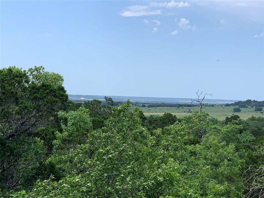This lot offers a natural backdrop, as the land located directly behind it is not planned for development based on current community information. Mature trees along the rear of the property provide a scenic and private setting. The Retreat community is located near the Brazos River and all within an hour drive of both Dallas and Fort Worth. The community offers a variety of amenities, including a gated community with two swimming pools, an 18-hole golf course, a clubhouse with on-site dining, a pro shop, an exercise room,  hiking trails, and a community park.