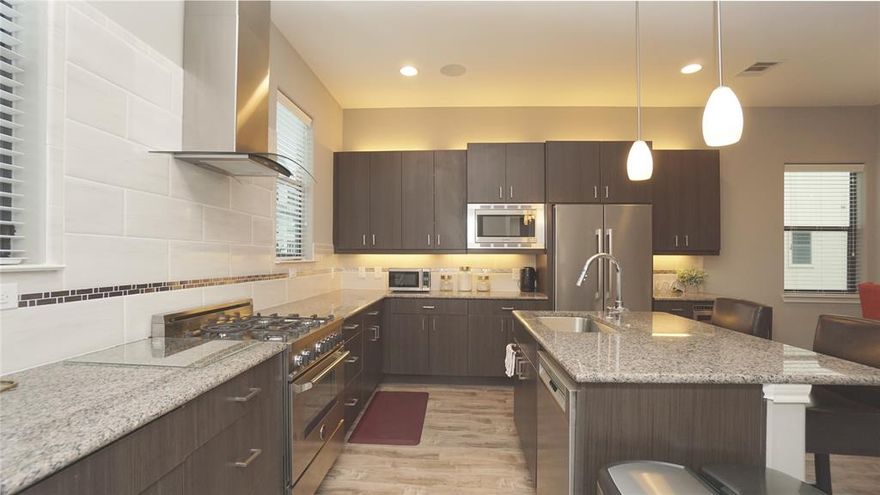 Sophisticated 3 beds, 3.5 bath townhome in the vibrant & convenient Ross Ave corridor. Minutes rom downtown, Lower Greenville, Uptown, Art District, Highland Park and many new development surrounded. Guest BR with ensuite bath is on 1st floor with it's own private entrance and yard access. A modern open-concept living-dining-kitchen is on the 2nd floor with a guest bath off the kitchen and a long private balcony outside the living room. high ceiling, fresh new paint, fireplace, BOSCH SS appliances, granite counter, wine cooler, wood flooring, REFRIGERATOR, WASHER & DRYER are included. All bedrooms have EN-SUITE bathrooms, walk-in closets, lots of storage spaces. Master on third level with an 2nd bedroom that can work as private home office or nursery.  Enjoy skyline view & sunbathing at Private Rooftop deck.  Gated community also offers private dog park adjacent to townhome.