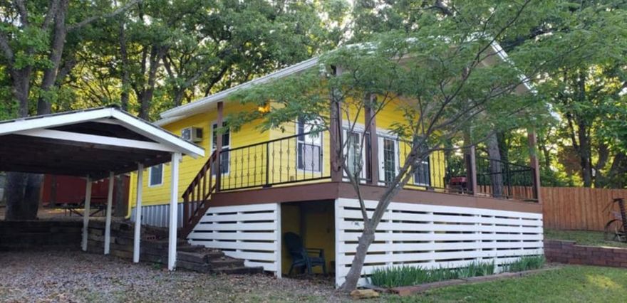 Lake Texoma view from the amazing covered deck! This charming home was completely gutted to the studs.* New electrical, new plumbing, and new sheetrock inside.* Metal roof.*This is NOT your Grandmom's typical 1960 cottage.* They kept the original pine floors! Open living area with kitchen, dining and living flowing together. One bedroom with spacious closet and a bathroom. A stackable washer and dryer space is tucked near the kitchen. Enjoy early morning coffee on your front deck (270 square feet of deck space) where you can see the lake. This lot is actually TWO lots together so there's room to park a boat or RV. RV parking is ready to go with electric and sewer hookup. Grill, play games, or string up a hammock for lazy lake days. Store your lake toys in the large shed or beneath the deck. The shady quiet lot creates a lovely get away and it's an easy distance to the lake front park. Terrific vacation rental potential. This home is 10 minutes from Megastar Casino and only 45 minutes to either Winstar or Choctaw. It's close to other hiking trails. There are several nearby marinas where you can slip your boat into the lake. Add a little sunshine to your life with this cheerful yellow cottage. Refrigerator stays.