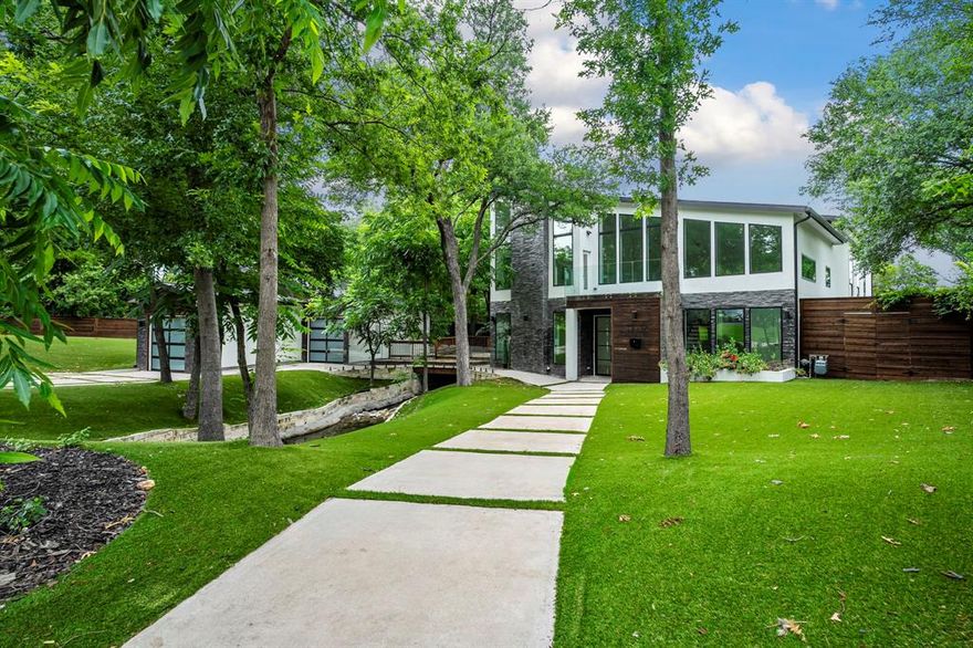 Luxury and comfort blend effortlessly in this exceptional open-concept home at 13032 Copenhill Road, situated in one of Dallas’ most desirable neighborhoods. With 6 spacious bedrooms, multiple living areas, a cozy loft, and a dedicated media room, this expansive residence is thoughtfully designed to accommodate both everyday living and upscale entertaining. Step inside to discover low maintenance flooring and custom light fixtures throughout, adding style and warmth to every space. The heart of the home is the chef-inspired kitchen, featuring stainless steel appliances, a large center island, and seamless flow into the dining and living areas—perfect for gathering with family or hosting guests in style. A wine cellar tucked beneath the stairs adds a unique and elegant touch. Outdoor living is just as impressive. Enjoy your private resort-style backyard complete with a sparkling pool and spa, custom putting green, and a meandering stream that adds serenity to the beautifully landscaped surroundings. Low-maintenance turf in both front and back yards ensures year-round curb appeal, while a tall privacy fence provides peace and seclusion. Multiple balconies and deck areas offer a variety of spots to relax, entertain, or simply enjoy the outdoors. A detached 3-car garage provides ample parking and storage, completing the home’s long list of desirable features. 13032 Copenhill Road is more than just a home—it’s a lifestyle destination. From its flexible layout to its luxurious finishes and thoughtfully designed outdoor spaces, this property offers the perfect blend of timeless elegance and modern convenience. Don’t miss your chance to own this rare Dallas gem.