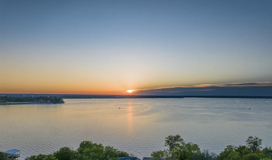 Scheduled for completion in January, 2026 - Privacy, Luxury, Proximity and Endless Lake Views! Welcome to a rare opportunity to own lakefront property on Eagle Mountain Lake. This exquisite 2.43-acre estate boasts a stunning 6,343sf luxury home with impeccable attention to detail and premium custom features throughout, this spectacular home offers unmatched quality.  Designed by renowned architects Far + Dang, built by luxury home builder LR Fine Homes, interior design by Susan Semmelmann, with custom tile curation by Erin Adams Designs this estate promises to be a unique refuge upon completion. With the highest elevations and deepest waters of Eagle Mountain Lake, this house was designed with floor to ceiling windows for natural light, jaw dropping panoramic views and unlimited sunsets. For the true gourmet a kitchen with custom cabinetry, Subzero, Wolf and BlueStar appliances, custom wine case, wet bar and scullery. The spacious primary suite features a private patio, fireplace, coffee bar, large bathroom and custom closet. An indoor atrium ideal for growing herbs and enjoying morning sunrises. The property has an additional 1,200sf air conditioned garage providing ample space for vehicles, with a detached 360sf air conditioned building, perfect for an office or art studio. A newly constructed dock awaits, complete with a boat slip and two jet ski lifts. Over 2,000sf of outdoor deck space with a 40’ long pool, tanning ledges and heated spa. Gated entry, solar power, with room for sports courts or helipad. Adjacent to the neighborhood is the 3,621-acre Fort Worth Nature Preserve. Downtown Fort Worth is only 14 miles and the Stockyards 11 miles, YeeHaw!