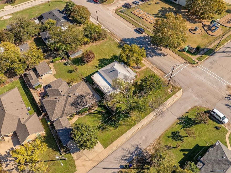 Use of Preferred  Lender will offer to pay .75 points of buyer’s closing costs. Call TODAY to see if you Qualify! 
Discover this charming 3-bedroom, 1.5-bathroom home with an additional storage building, nestled in the heart of historical Downtown Krum. Conveniently located on a corner street directly across from Hattie Dyer Elementary, this delightful residence blends enchanting original elements with modern updates. Enjoy updated windows that flood the space with natural light, along with updated kitchen cabinets for ease of use and mature landscaping that adds to the curb appeal charm.The home features three generously sized bedrooms with closets, high ceilings, and 1.5 baths for easy morning routines. A full-size laundry room provides access to the backyard, while the cozy living room invites you to relax and unwind. The kitchen serves as the heart of the home, offering ample storage and space for a full-size kitchen table, making entertaining a breeze. Whether hosting a crowd or just a few guests, there is plenty of room for everyone. Additionally, a storage building on the property enhances the home's functionality by providing extra space for your storage needs. This property is being sold as-is, presenting a unique opportunity to make it your own in a prime location.