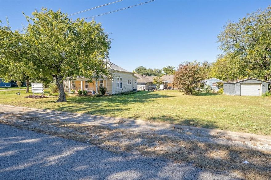 Use of Preferred  Lender will offer to pay .75 points of buyer’s closing costs. Call TODAY to see if you Qualify! 
Discover this charming 3-bedroom, 1.5-bathroom home with an additional storage building, nestled in the heart of historical Downtown Krum. Conveniently located on a corner street directly across from Hattie Dyer Elementary, this delightful residence blends enchanting original elements with modern updates. Enjoy updated windows that flood the space with natural light, along with updated kitchen cabinets for ease of use and mature landscaping that adds to the curb appeal charm.The home features three generously sized bedrooms with closets, high ceilings, and 1.5 baths for easy morning routines. A full-size laundry room provides access to the backyard, while the cozy living room invites you to relax and unwind. The kitchen serves as the heart of the home, offering ample storage and space for a full-size kitchen table, making entertaining a breeze. Whether hosting a crowd or just a few guests, there is plenty of room for everyone. Additionally, a storage building on the property enhances the home's functionality by providing extra space for your storage needs. This property is being sold as-is, presenting a unique opportunity to make it your own in a prime location. Sellers have e provided a full home inspection in Documents in MLS.