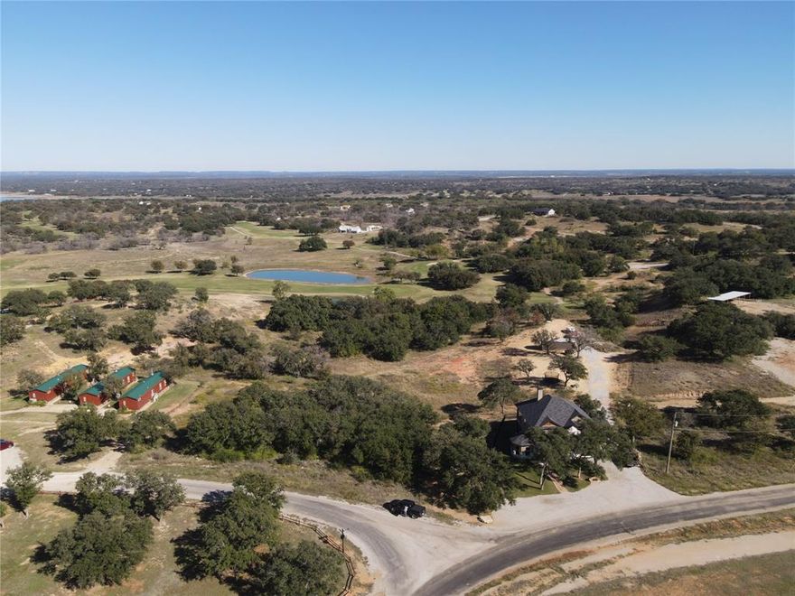 Very very nice lot in a spectacular location in the beautiful Hideout Resort. This is one of the largest lots in the area, and certainly the largest lot listed at the time of listing. If you are looking for an exclusive lot in an exclusive area, this is the one. With over and acre of land to work with, there are multiple areas you could build on. Clear a few trees and have the number 1 green and the number 2 tee box in your backyard. Enjoy the evening on your back porch while watching group after group dunk their balls into the large pond next to the green. The entertainment possibilities are endless. This lot is located in The Hideout Resort and purchase of the lot gives you access to all of the amenities that The Hideout has to offer. Purchase of this lot gives you 4 free rounds of golf each month along with a great practice area and driving range. Also included is the unlimited use of the pools and the cabins located on site, as well as the pickleball courts and the gym!! There is also an RV park on the property so you could have your friends or family come stay close by, but not too close by, on holidays and over the summer! Come check out The Hideout, today, and make this piece of Texas YOUR next piece of Texas.