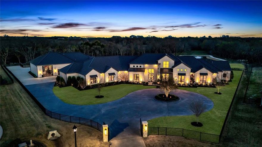 The Estate at Honey Lane redefines luxury living, blending impeccable craftsmanship with cutting-edge design on 5.5 acres within an exclusive gated community with private gate access. This home offers an extraordinary lifestyle, where sophistication and first-class amenities come together. As you step inside, captivating designer light fixtures illuminate the meticulously curated spaces, setting the tone for the refined atmosphere. The gourmet kitchen is a true culinary haven, with a double waterfall island, top-of-the-line appliances including a sub-zero refrigerator and wine cooler, La Cornue French range, rotisserie, and a spacious prep kitchen to make every meal a masterpiece. For wine connoisseurs, a dedicated temperature controlled wine room offers the perfect environment to showcase your collection. The home is equipped with a state-of-the-art audio and video system for premium sound and entertainment. The home theatre suite and personal fitness center provide ideal spaces to unwind or stay active, while unique features like a custom barbershop, sauna, and indoor batting cage further elevate the home’s distinctiveness. The entertainment lounge boasts a beverage center, dual-zone wine fridge, ice maker, and a motorized glass door that opens to the back yard creating the perfect setting for guests to gather. The primary suite includes a stone tub, stunning grande glass shower, dual vanities, backlit mirrors, and a designer closet system. The home also offers a private vault for valuables and a spacious laundry room with a sink, dog wash station, and ample cabinetry. Outdoors, enjoy the extended patio, putting green, heated pool and spa, firepit, and outdoor kitchen that includes a 42” Lynx grill, pizza oven, and beer tap. A walking trail around the stocked pond provides a peaceful retreat. Every element of this one-of-a-kind residence has been thoughtfully designed to elevate luxury living to new heights, offering an unmatched and extraordinary experience.