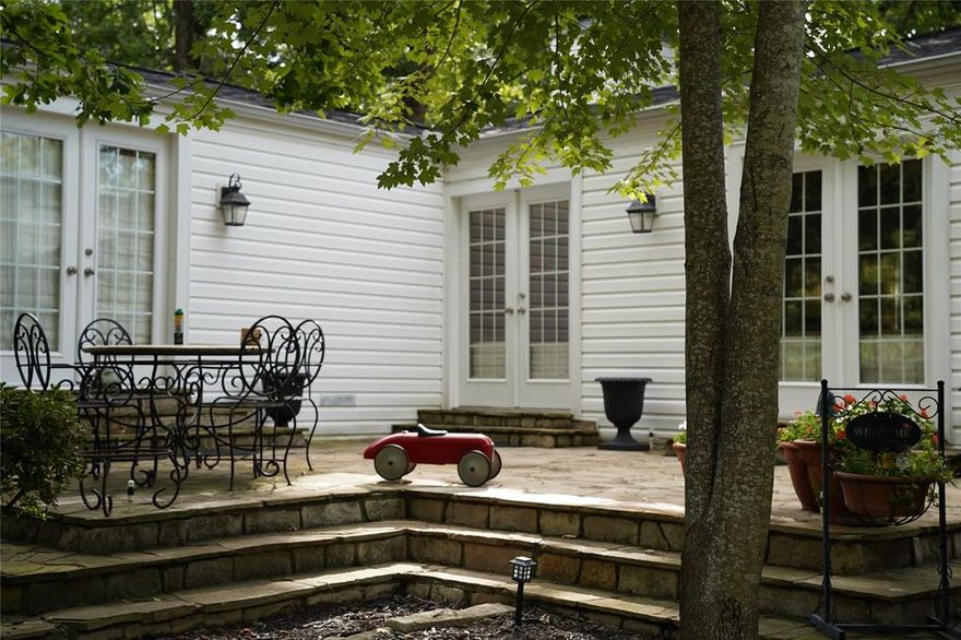 180 Harbor Drive is a waterfront property on over one acre, offering privacy, mature trees, rolling terrain, and a retreat-like setting. The main home is approx. 2,350 sq ft with 3 bedrooms and 3 full baths, plus a separate 2-bedroom, 1-bath guest house on its own lot with independent utilities—ideal for extended family, guests, rental income, or potential resale for added value.

Over $250,000 has been invested in renovations over the past two years, enhancing the home, guest house, garage, and grounds. The exterior has a subtle Cape Cod influence, while the interior features Tuscan archways, warm finishes, and 10 sets of French doors with direct access to outdoor living areas. Amenities include a large covered porch, two elevated decks, shaded landscaping, gentle slopes, a natural stream, and water access with limestone rockwork and two small bridges.

The property is fully fenced with premium black metal fencing and a custom hand-built cedar entry gate with automatic access.

Additional improvements:

- New central HVAC + mini-splits
- Roof, foundation, plumbing, electrical, and windows all in excellent condition
- New 1,200 sq ft (30’x40’) garage with 11-ft doors and large concrete slab
- Extensive drainage, grading, irrigation, and stonework
- Dozens of mature shade trees ensuring privacy
- Three wooded lots across the street to prevent future development

HOA includes a private boat launch ramp and park. 

A unique, high-quality property offering land, privacy, and multiple living options—nothing comparable on the market in layout, setting, or detail.