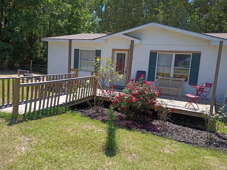 Well-maintained Double wide manufactured home located on 1.4 acres with beautiful mature trees and back seasonal creek. Enjoy your morning coffee on the back patio deck surrounded by trees and listening to the birds. Interior offers open concept with new flooring in living room, kitchen and dining area. Large back patio deck offers privacy, surrounded by trees and overlooking creek. Plenty of space for entertaining family and friends. Property offers 3BR, 2Bath, laundry area located in primary closet area. The cutest shed with electric great for crafts, office, workout room. Large metal workshop approximately 28x35 with electricity, perfect for the handyman. Bring your RV there's electric hookup already on site. When you drive up to property you will be greeted with excellent curb appeal, 2 very tall pine trees are breathtaking. This property has endless possibilities. Backyard has chain link chicken coop and Dog run in place.  Look no further! Schedule your showing today. Manufactured home has previously been moved. All information must be verified.