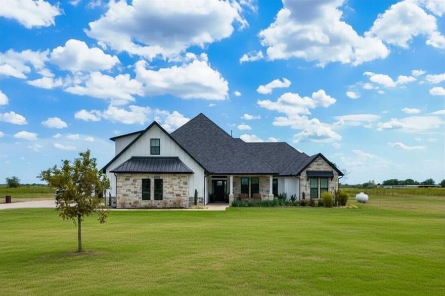 Looking for a Texas farmhouse on acreage with a pool and pond? This private retreat sits on 9.66 acres and offers the perfect blend of luxury, privacy, and country living just outside the city.
The custom home features 4 bedrooms, 3 bathrooms, a dedicated office, bonus room, and over 3,600 sq ft of living space designed for both comfort and entertaining. Inside you’ll find wide-plank flooring, designer lighting, and an open-concept layout connecting the living room, dining area, and kitchen.
The chef’s kitchen includes premium appliances, an oversized island, soft-close cabinetry, and a striking coastal-style backsplash. Large windows throughout the home bring in natural light and showcase the peaceful views of the surrounding land.
A cozy sunroom overlooking the backyard is perfect for morning coffee, while the expansive front porch offers beautiful Texas sunset views.
Enjoy a resort-style pool with tanning ledge and LED lighting, your own stocked fishing pond, and nearly 10 acres of land with room to build a shop, barn, or guest house. A detached storage building is already in place for equipment, hobbies, or recreational gear.
Located in a top-rated school district, this property also offers ag exemption eligibility in one year and no city taxes, making it an ideal opportunity for buyers looking for Texas land, luxury, and long-term value.