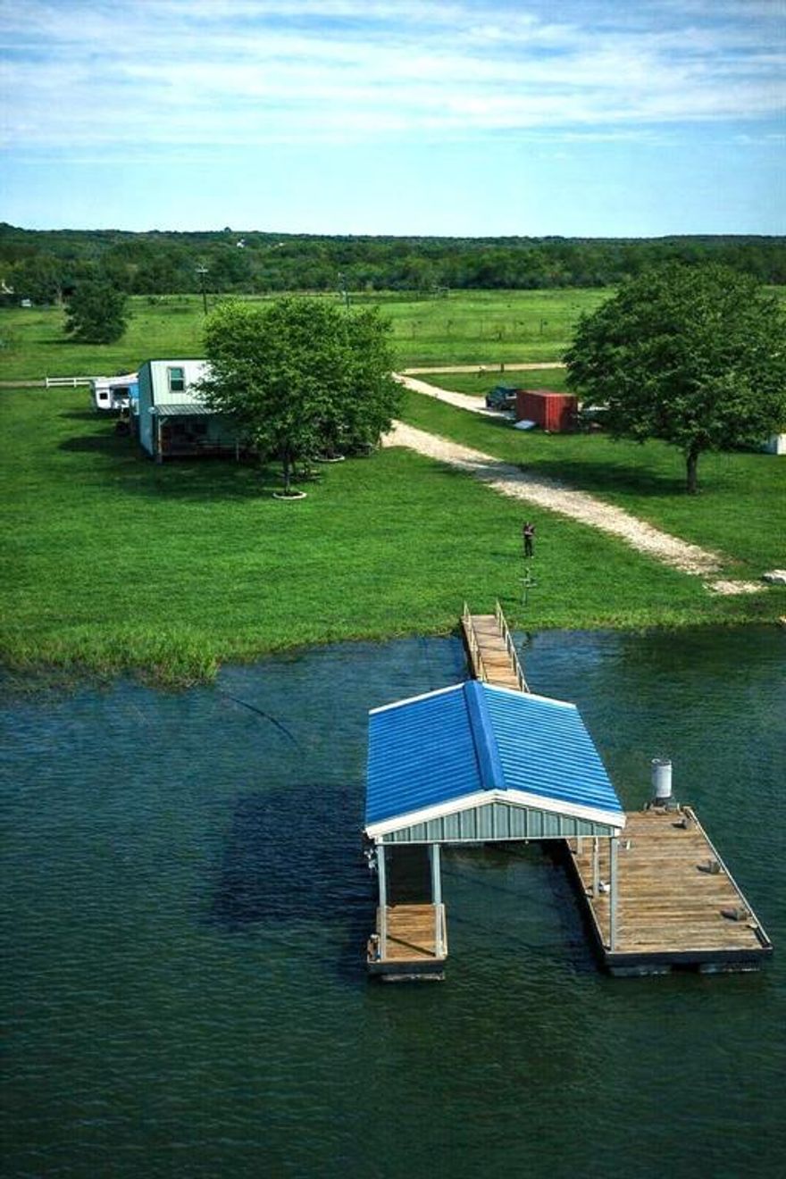 Just a short drive from the DFW area, the Eastland Cabin offers the perfect lake getaway and your own private retreat. Currently an AirBnB with great income potential, it rents for $200 a night, and 2025 rental income details are available on request. This fully furnished lakefront escape features 3 bedrooms, 1.5 baths, a private boat ramp, a covered boat dock with lift and fish cleaning station, and stunning lake views from two bedrooms and the great room. You’ll also enjoy stainless steel appliances, a full-size stackable washer and dryer, a spacious covered deck overlooking the water, and 3 RV hookups with separate connections—ideal for renting out or hosting family with their own RVs. It’s a turnkey vacation spot where you can create lasting memories while earning extra income
