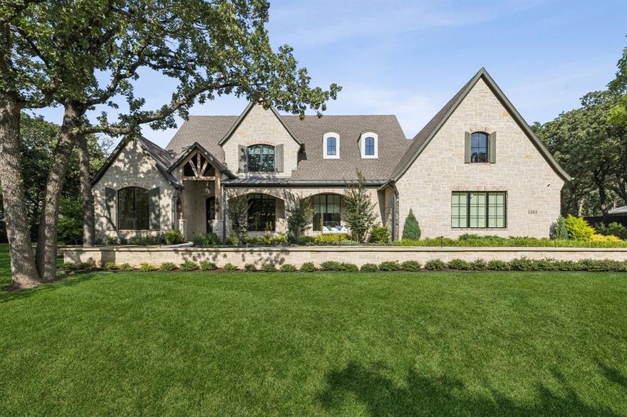 Discover luxury living in this stunning Lorant and Elliott Estate Homes MASTERPIECE on over 1 acre in Southlake. This 5,879 sq ft treasure showcases impeccable craftsmanship with European white oak floors, designer shades, lighting, and natural stone throughout. The gourmet kitchen features an oversized Taj Mahal island, complete Thermador appliance suite including a 6 burner gas range with griddle, vent hood, double ovens, and is adjacent to the butler's pantry. The open concept flows seamlessly to the family room with custom wood beams and floor-to-ceiling stacked stone fireplace. Four bedrooms include a lavish primary suite with sitting area, motorized shades, custom fireplace, Hollywood soaking tub, and walk-in shower. Two studies and entertainment areas with wet bars offer versatile spaces. Resort-style outdoor living awaits with sparkling pool and spa, covered patio featuring outdoor kitchen, gas grill, and cozy fireplace. Exemplary Carroll ISD. Every detail reflects sophisticated elegance in this extraordinary home where luxury meets lifestyle!