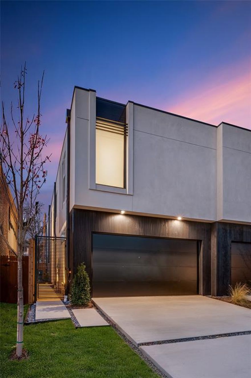 Stunning new construction duplex located in an unparalleled M-Streets location. This home offers the perfect blend of urban living and modern design, boasting an open and airy floor plan that maximizes natural light and expansive space. Upon entering, you'll be greeted by a floating metal staircase, a chic fireplace and mantel, and 7 skylights, all setting the tone for the home's contemporary elegance. The kitchen is a show stopper, featuring a striking waterfall island, custom cabinetry, panel front refrigerator and dishwasher, and under cabinet lighting. The downstairs office, which can be quietly closed off with its unique door system, fulfills all work-from-home needs. The primary bedroom is a tranquil retreat, complete with a en-suite bathroom with a walk-in shower, separate soaking tub, and a custom closet with ample space. The seamless indoor-outdoor flow is highlighted by a three-panel hidden door system, creating a seamless transition to the private landscaped backyard. Here, you'll find a cozy fireplace and a spacious patio, perfect for entertaining or enjoying a quiet evening under the stars. The 2 car garage is seamlessly built into the front facade. Zoned to Mockingbird Elementary and walkable to all of the fun and retail that Greenville offers.