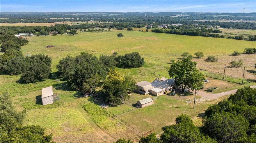 Farm house outside of town, but with a big country feel on approx. 5.81 acres. This country property has beautiful Live Oak trees with cross fencing and an area for raised plant beds for your garden. Currant owner added a new metal roof and a room with an indoor swimming pool. The views are amazing!