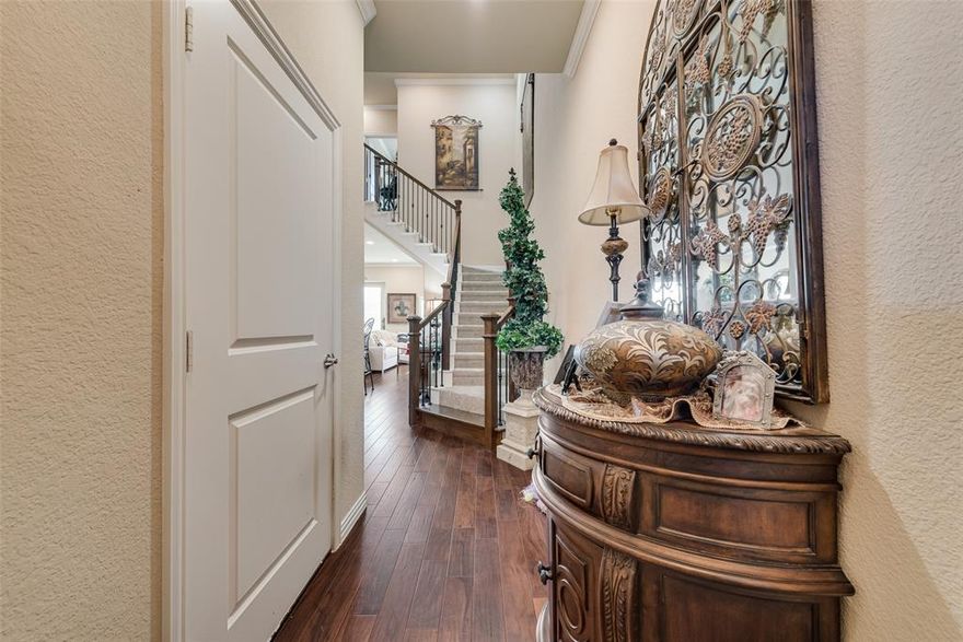 Meticulously maintained and move-in ready, this beautifully designed townhome offers a rare opportunity in Burleson, where townhomes are hard to find & even harder to match in quality. Designed for easy lock-and-leave living, this home combines low-maintenance convenience with upscale finishes throughout. Step inside to a grand entry featuring a stunning staircase with hardwood railing & decorative iron spindles. Rich hardwood floors flow throughout the downstairs living, dining, & kitchen areas, complemented by crown molding and an open, inviting layout. The spacious kitchen is a standout, offering abundant cabinetry, a large island, pantry, granite countertops, white shaker-style cabinets with brushed nickel hardware, tile backsplash, stainless steel appliances, and a double oven. It opens seamlessly to the oversized dining and living areas, creating the perfect space for entertaining. A sliding glass door with custom plantation shutters leads to a covered patio and a surprisingly generous backyard with landscaping, an uncommon feature for townhome living. Upstairs, all three bedrooms are efficiently laid out, along with a beautifully decorated hall bath featuring decorative tile, granite countertops, and an upgraded mirror. The primary suite is spacious and private, complete with a walk-in closet, balcony, and plantation shutters. The ensuite bath offers dual sinks, granite countertops, a separate soaking tub and shower, elegant tile work, and a large linen closet. A convenient upstairs utility room includes cabinetry and a built-in ironing board. Additional features include spray foam insulation for energy efficiency & a private 2-car garage.  The HOA covers exterior maintenance, lawn care, trash service, and roof & exterior insurance. The gated community also features iron fencing and park areas.  Located in Burleson ISD with easy access to shopping, lots of restaurants, and only a 7 minute drive to HEB! This home offers a luxury feel at an exceptional value!