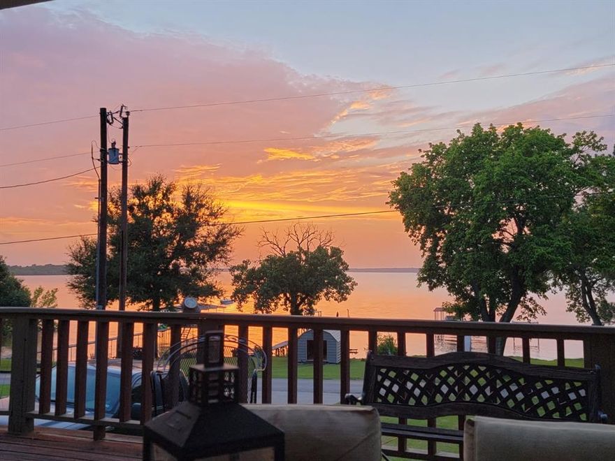 Stunning family lakeside retreat awaits! This waterfront home  features 2,688 sqft 5 bedrooms, 3.5 baths, custom knotty pine walls and cabinetry throughout. Granite counter tops in an open concept living to kitchen with breakfast bar. slate tile flooring, 2 Jack and Jill bathrooms. 1+ acres with scattered aged oaks.The front facing SRA lease is truly unique to this subdivision, watch the sunsets on the lake from your front porch.  The dock is metal framed with maintenance free composite decking. Pier features covered  boat lift, double jet ski lifts, motorized lift swimming platform. Gated community! Only 1 hour east of Dallas.