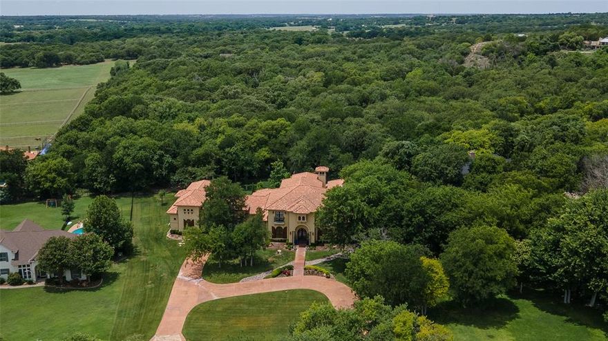 LUXURY living at its finest. This exquisite Mediterranean estate is located in Oakview Estates in Aledo ISD. Recently updated kitchen is entertainer's dream with Wolf and Sub Zero appliances, quartzite countertops and a huge prep island! Adjacent to this fabulous kitchen is a wet bar, breakfast room, butler’s pantry, wine cellar and dining room. The ground floor guest suite (separate entrance) has a bedroom, ensuite bath and a kitchenette. There is additional unfinished space upstairs for a living area or storage.  The pool house, cabana has an ensuite bath and could serve as 5th bedroom, guest suite, office, or game room. Between pool house and master suite is private covered loggia with wood burning fireplace. Upstairs has 2 large bedrooms with hardwood floors, ensuite baths, walk-in closets. Second floor media room has wet bar and private balcony overlooking pool-spa and heavily treed backyard. A large floored storage area is above the oversized 4-car garage. Backyard oasis.