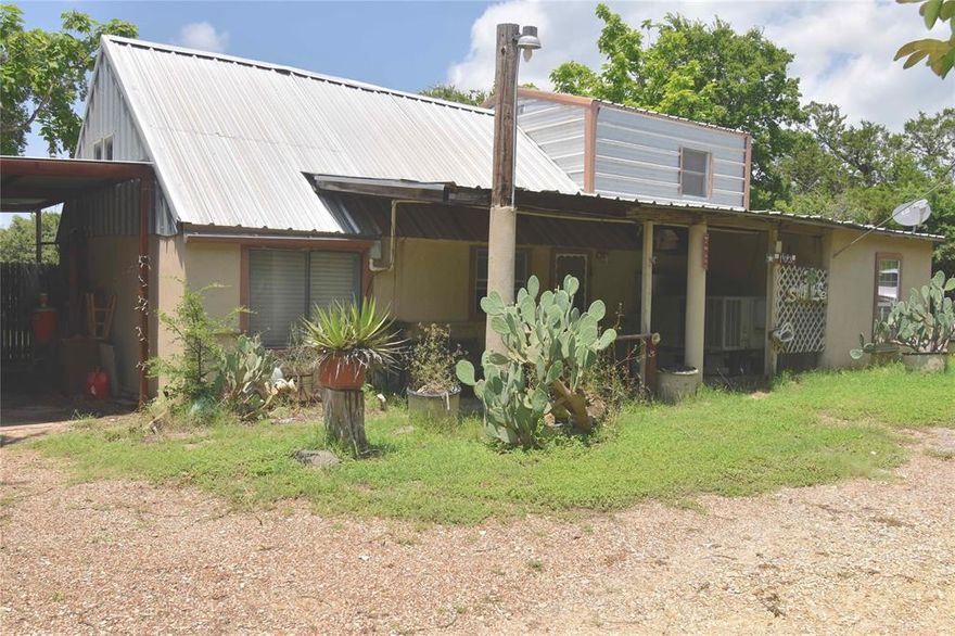 Country cottage, situated on 8276 square foot lot in a quiet rural setting on a cul-de-sac, built in 1999.  Only twelve miles to Lake Whitney State Park and four miles to downtown Whitney, with a close by Dollar General store. Two bedrooms, one up stairs, one bathroom downstairs . Fenced backyard with 3 storage buildings and wide gate, easy access for boat parking to One Feather Street.  Home exterior and interior needs work, great project for the handyman to remodel. Huge opportunity to evolve into a great lake retirement location.