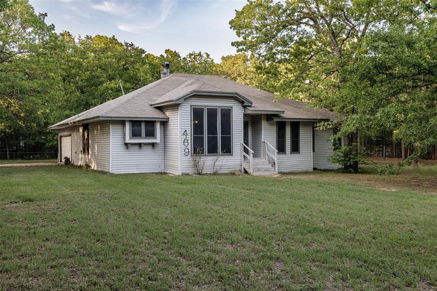 Charming home on just under an acre in Hunt County! The property is fully fenced with its own gated entrance for added privacy. Step inside to a great room featuring a cozy fireplace, built-in cabinets with a desk, and a fun 70’s-style wet bar. This three-bedroom, two-bathroom gem offers two spacious living areas with beautiful natural woodwork and two dining rooms—perfect for entertaining. Homes like this aren’t made anymore- it’s full of character and ready for new owners. With a bit of TLC, it could be your dream home! Conveniently located just minutes from local restaurants, shops, and Lake Tawakoni, which spans about 37,879 acres and is famously known as the catfish capital of Texas for its outstanding fishing. Seller is motivated, bring all offers! All information is approximate; buyers and their agents to verify.